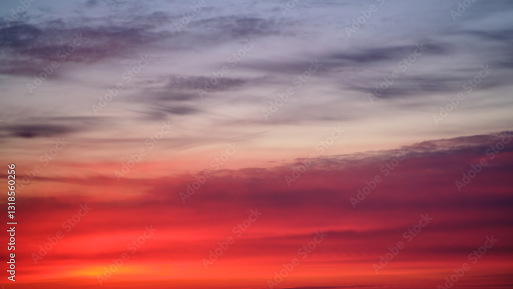 Fototapeta premium Dramatic sky with red, pink, and purple clouds at sunset, copy space. Nature background for design and print
