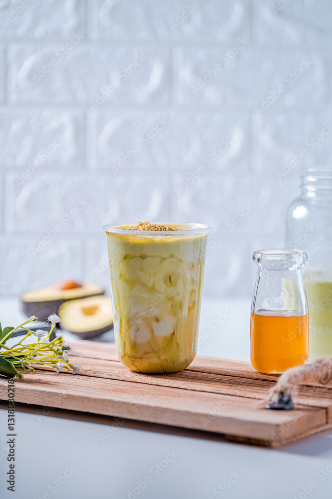 A glass of avocado smoothie with fresh honey A glass of avocado smoothie with fresh honey