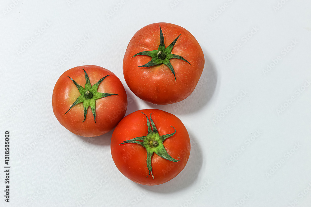 Three large natural tomatoes on a white background Three large natural tomatoes on a white background