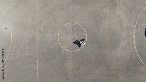 Aerial Birds Eye view of a child riding a bicycle 