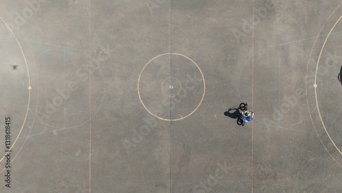 Aerial Birds Eye view of a child riding a bicycle 