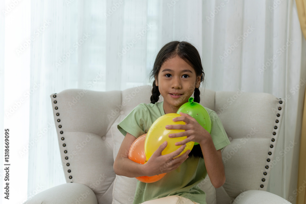 Colorful Balloons Celebration with Child Sitting on Beige Armchair Colorful Balloons Celebration with Child Sitting on Beige Armchair
