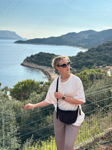 Coastal travel portrait of a woman by the sea, digital nomad and retreat vibe, blue water and island bay, summer vacation lifestyle, wellness slow travel and mindful escape, scenic background with cop