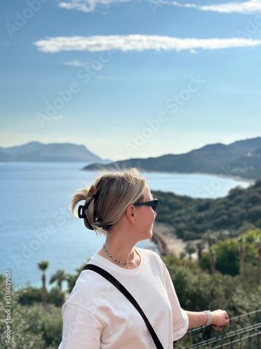 Coastal travel portrait of a woman by the sea, digital nomad and retreat vibe, blue water and island bay, summer vacation lifestyle, wellness slow travel and mindful escape, scenic background with cop
