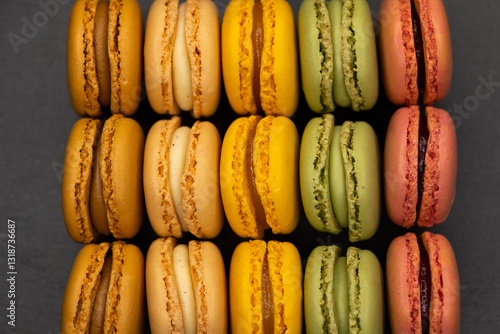 Obraz na płótnie macaroons of different colors on a black background w salonie