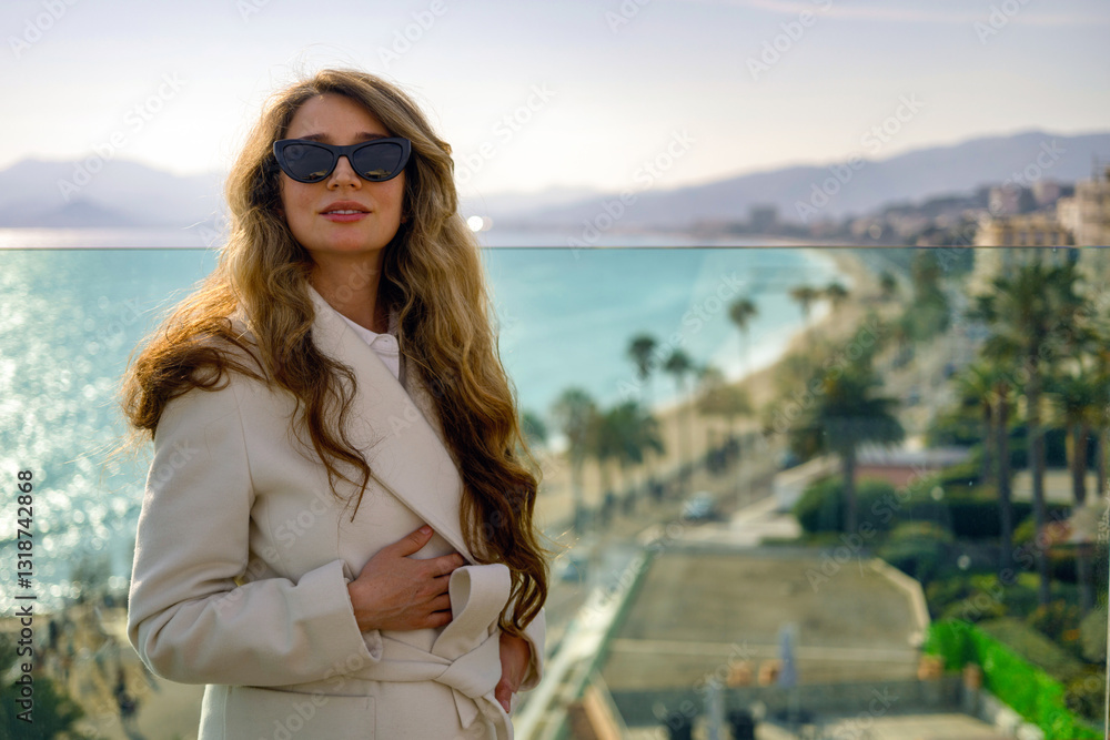 Woman posing in Cannes at a rooftop bar, France, sea and mountains