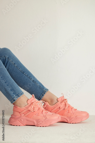 Obraz na płótnie detail of sitting woman wearing pink trainers and jeans w salonie