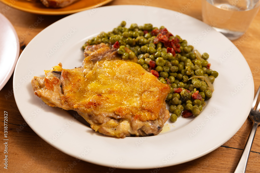 Delicious crispy chicken with peas as a side dish on a plate Delicious crispy chicken with peas as a side dish on a plate