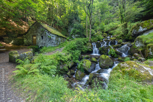 Obraz na płótnie Water wheel mill (Moulin de Chambeuil) with waterfalls, Laveissiere, Cantal, Auvergne-Rhone-Alpes, France w salonie
