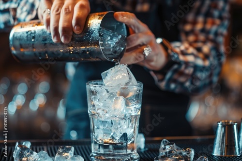 Alcohol Drinks,People and Luxury Concept Bartender Adding Ice Into Shaker Preparing Cocktail at Bar