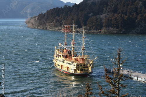 a traditional pirate ship docks at a harbor in the Hakone Lake in Japan, at the foot of the fuji mountain