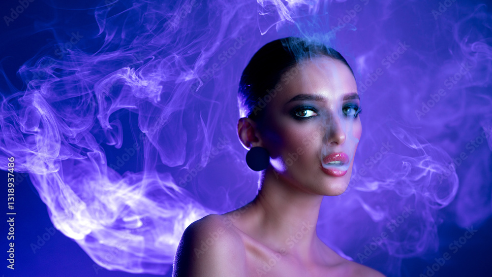 Stylish lady smoking vape or e-cigarette and posing over neon blue light and looking at camera, panorama with free space Stylish lady smoking vape or e-cigarette and posing over neon blue light and looking at camera, panorama with free space
