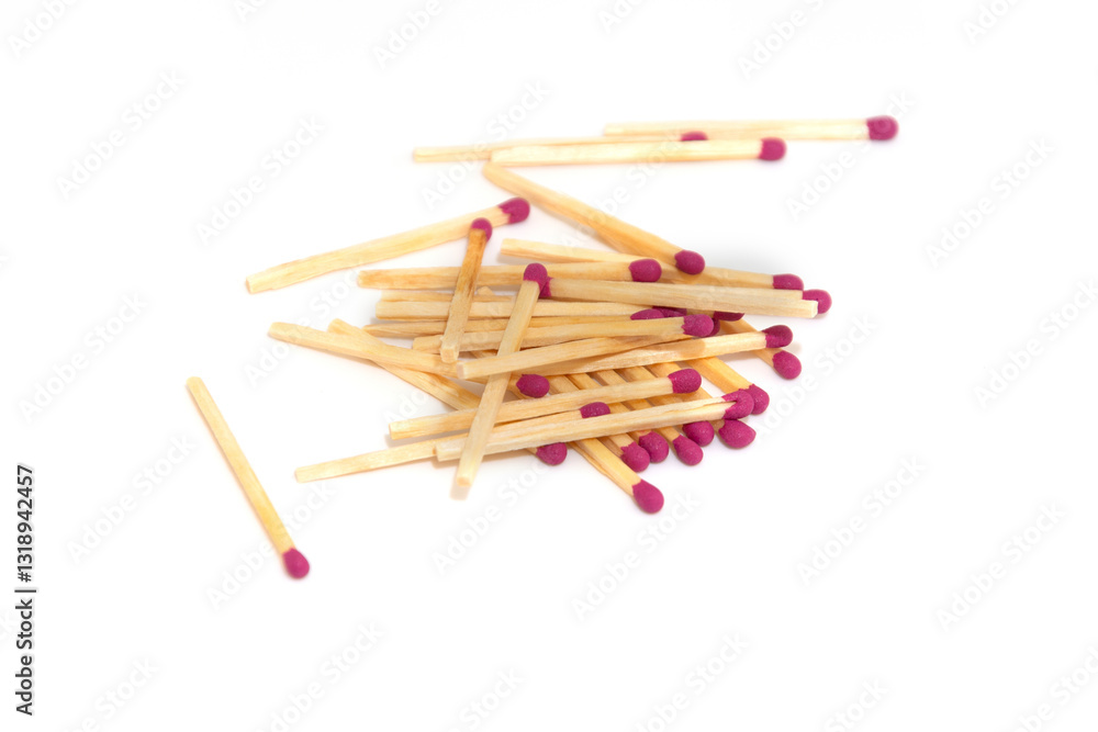 Wooden matches with red tips scattered on a white background. Wooden matches with red tips scattered on a white background.