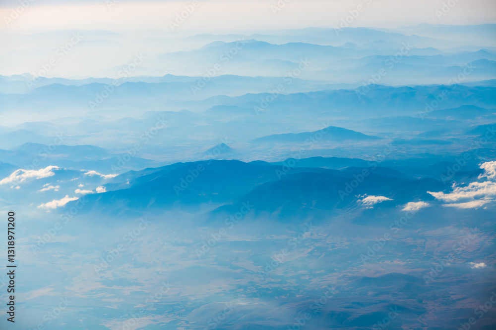 A view of the planet Earth, a view from an airplane, mountains and clouds A view of the planet Earth, a view from an airplane, mountains and clouds