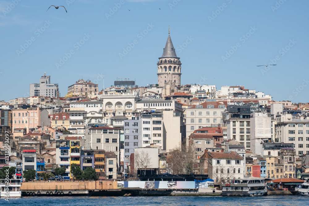 Obraz premium Istanbul Skyline with Galata Tower and Bosphorus Waterfront: Panoramic View of Historic Turkish City with Tourist Boats and Harbor in Mediterranean Coastal Landscape