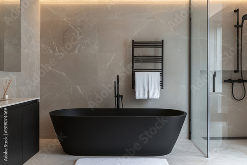 Modern bathroom featuring a sleek black bathtub and elegant design elements.