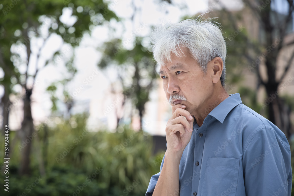 Pessimistic Asian senior man thinking seriously, planning something with stressed mood and bad feeling Pessimistic Asian senior man thinking seriously, planning something with stressed mood and bad feeling