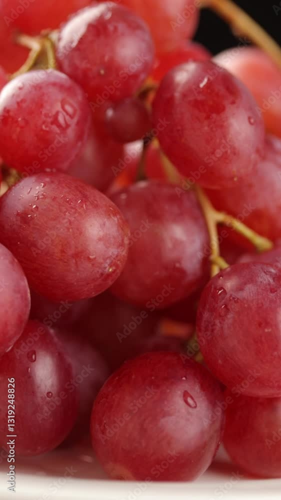Red seedless grapes with water drop rotating. Close-up Red seedless grapes with water drop rotating. Close-up