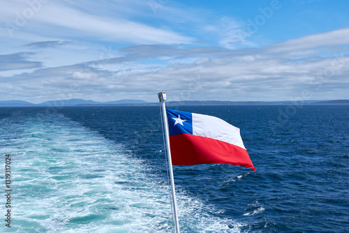 Cuadro en lienzo Chilean flag waving on the stern of a ship with the wake of navigation in the ba