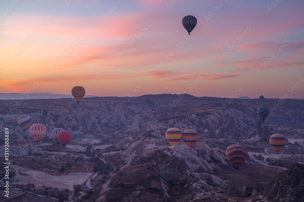Early morning view of hot air balloons rising up in Cappadocia, Turkey