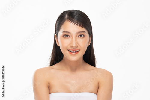 Billede på lærred Asian young woman with smooth skin and long dark hair smiles confidently against