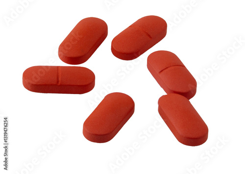 red pills on white background: medication and health
