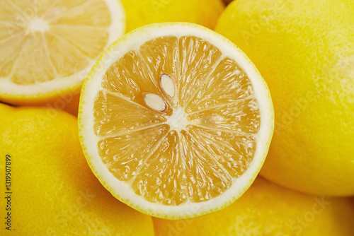 Full frame close-up of a halved lemon on a stack of lemons