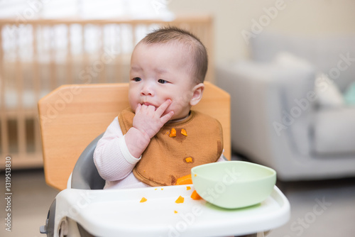 Toddler enjoying mealtime at home table