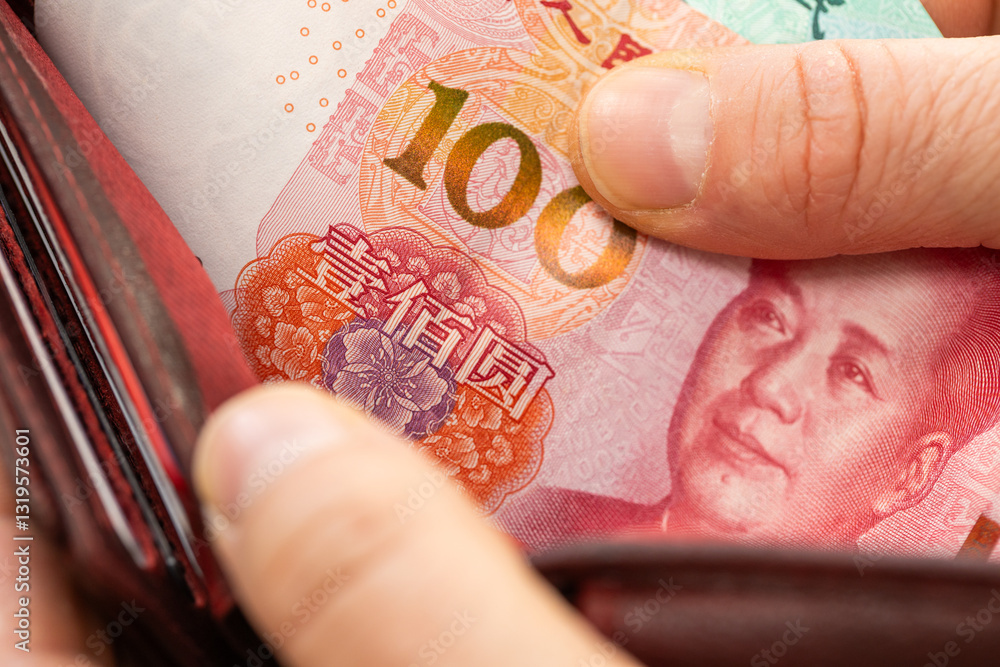 Chinese yuan taken out from wallet, financial concept