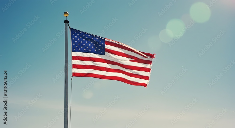 Fototapeta premium A Majestic American Flag Waving Proudly Against a Clear Blue Sky