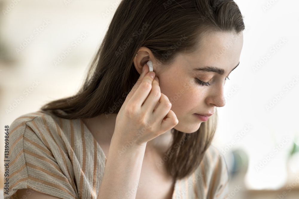 Clear sound in one touch. Close up young beautiful girl enjoy easy interaction with digital in-ear headphones press button to switch device adjust audio volume to stay connected with favorite music Clear sound in one touch. Close up young beautiful girl enjoy easy interaction with digital in-ear headphones press button to switch device adjust audio volume to stay connected with favorite music