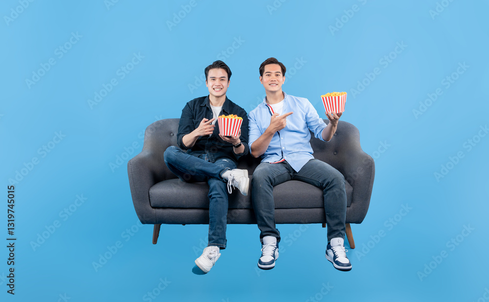 Movie Night Buddies: Two friends share popcorn on the couch, ready for a film. Relaxed and pointing, excitement fills the air! Movie Night Buddies: Two friends share popcorn on the couch, ready for a film. Relaxed and pointing, excitement fills the air!