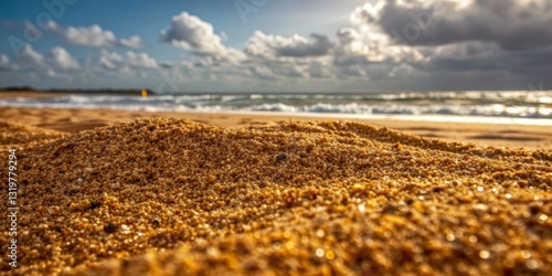Obraz na płótnie Sandy beach under cloudy sky with gentle waves rolling in during sunset w salonie