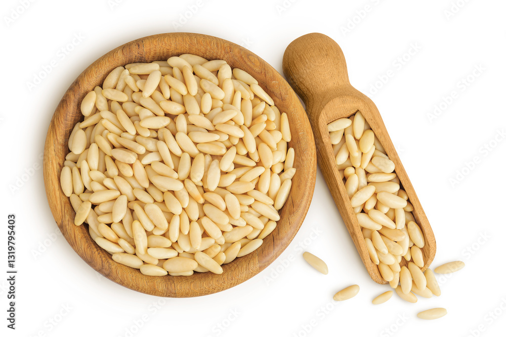 Shelled European pine nuts in wooden bowl and scoop isolated on white background. Top view. Flat lay Shelled European pine nuts in wooden bowl and scoop isolated on white background. Top view. Flat lay