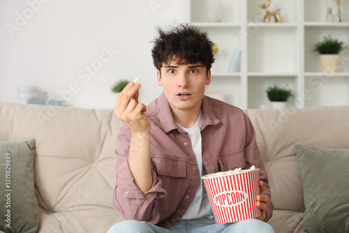 Young shocked man watching ...