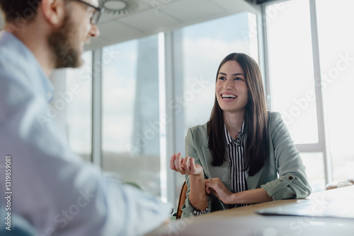 Smiling Woman Engaged in a Positive Business Meeting Discussion at the Office