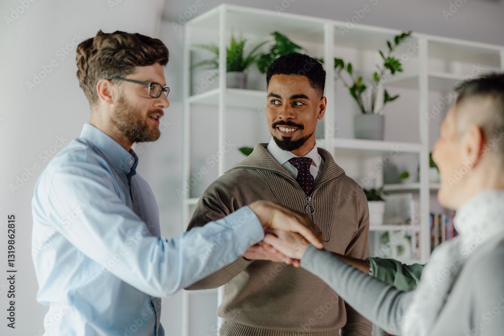 Obraz premium Team Members Shaking Hands During a Collaborative Business Gathering in a Bright Office