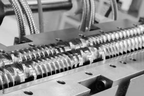 Spiral screw shaft for feeding granules into production machine for manufacture products from pvc plastic extrusion technology industrial concept background