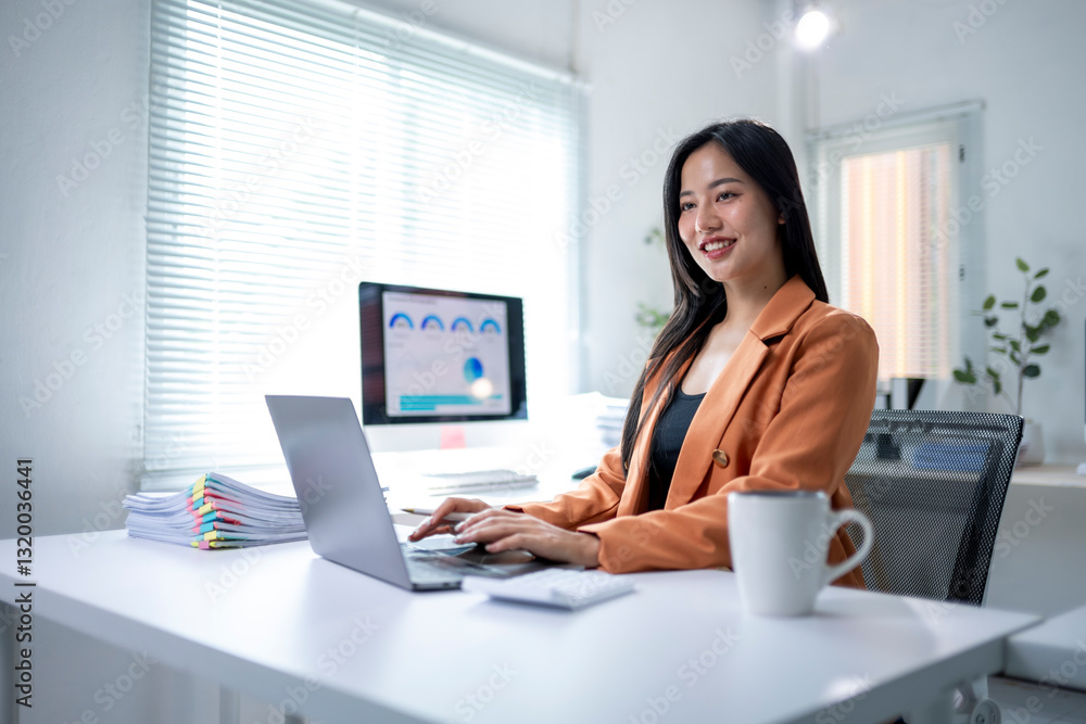 A woman is sitting at a desk with a laptop and a cup of coffee A woman is sitting at a desk with a laptop and a cup of coffee