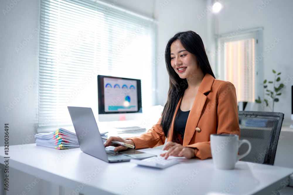A woman is sitting at a desk with a laptop and a cup of coffee A woman is sitting at a desk with a laptop and a cup of coffee