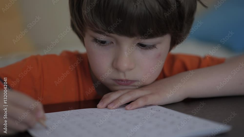School Boy Practicing Writing Numbers at Home. Child Working on His Homework. Little Boy Studying Learning at Home. Child, Learning Doing Math for Education, Making Homework Numbers in His Room. School Boy Practicing Writing Numbers at Home. Child Working on His Homework. Little Boy Studying Learning at Home. Child, Learning Doing Math for Education, Making Homework Numbers in His Room.