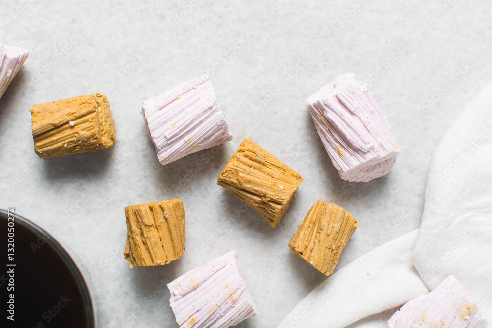 Overhead view of Nigerian Balewa candy, top view of hausa alewa candy on a white background, pulled hard sugar candy on a white countertop Overhead view of Nigerian Balewa candy, top view of hausa alewa candy on a white background, pulled hard sugar candy on a white countertop