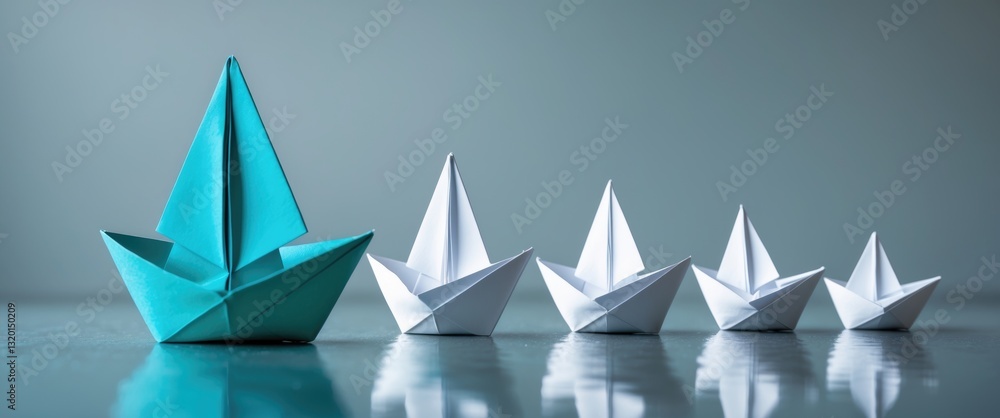 Obraz premium Leadership concept featuring a blue paper ship guiding among white ones.