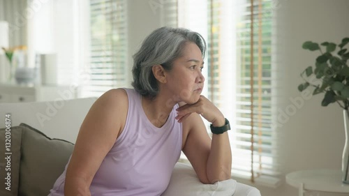 Asia adult boring people middle age old woman sit angry at sofa home anger hot flash elder mental health care aging issue. Aged stress bored toxic pain sad upset face. Female asian burnout support.