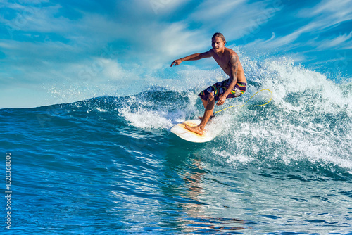 Male surfer on a blue wave at sunny day