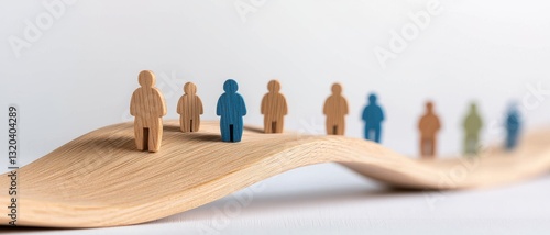 leadership community figure wooden concept. Wooden figures on a wave-like surface represent unity and diversity.