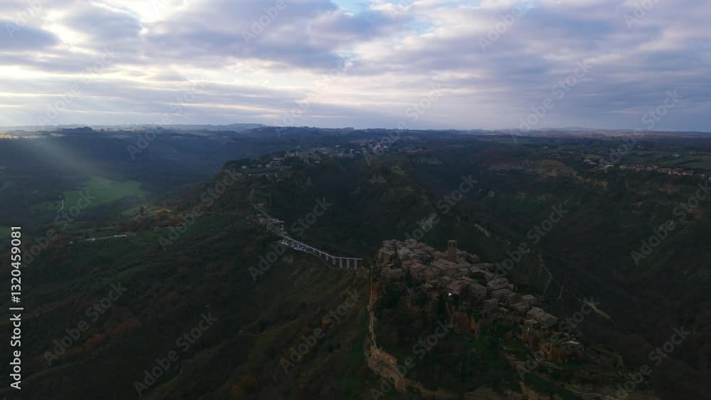 Civita di Bagnoregio, ancient hilltop village, sun rays, lush valleys and rolling hills, perfect for travel or history footage, Viterbo in Italy. Aerial drone orbiting Civita di Bagnoregio, ancient hilltop village, sun rays, lush valleys and rolling hills, perfect for travel or history footage, Viterbo in Italy. Aerial drone orbiting