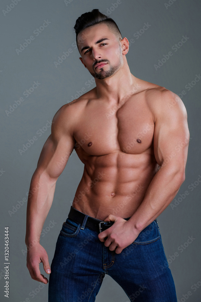 Fototapeta premium Sexy topless shirtless young man. Handsome muscular man. Sexy body of fit male sexy model. Beauty man with perfect muscular body. Hot naked young middle eastern guy enjoying his muscular body.