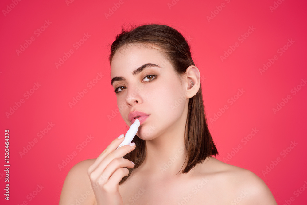 Studio portrait of beautiful woman with red lipstick. Beautiful young woman applying lipstick on her lips, isolated on studio background. Studio portrait of beautiful woman with red lipstick. Beautiful young woman applying lipstick on her lips, isolated on studio background.