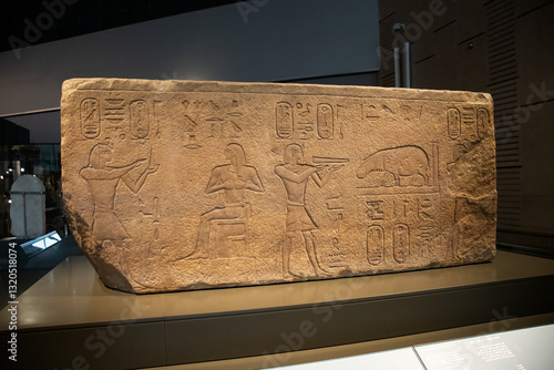 ancient Egyptian carvings and hieroglyphs on sand stones at the Grand Egyptian Museum in Cairo, Egypt